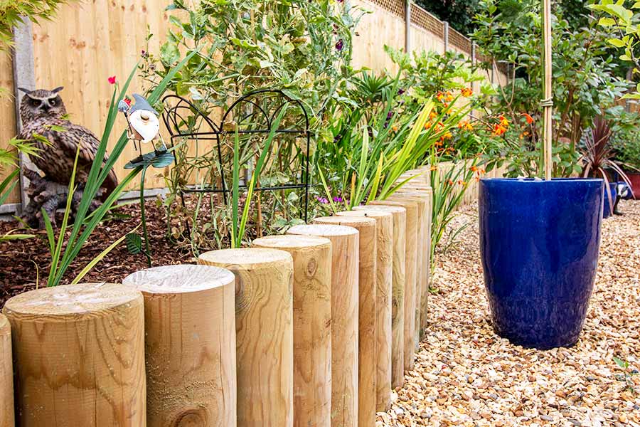 Retaining garden walls made using landscaping poles